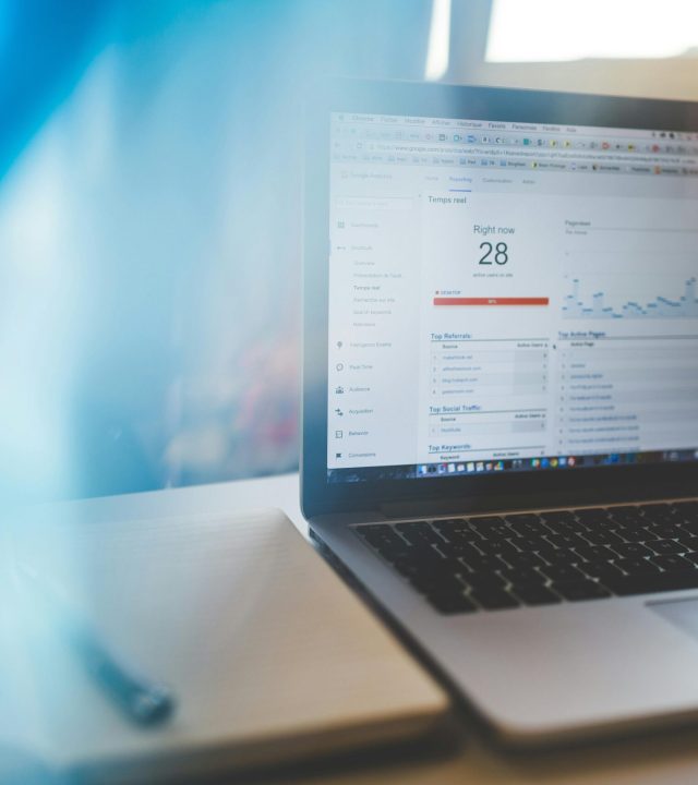 Laptop displaying Google Analytics in a modern workspace, highlighting digital analytics and technology.